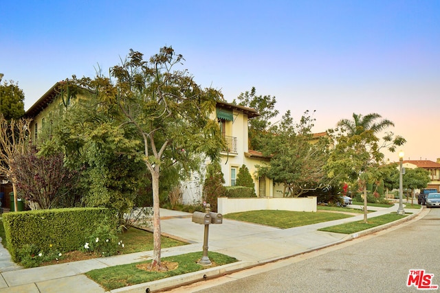 mediterranean / spanish house featuring a yard