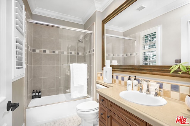 full bathroom with vanity, toilet, bath / shower combo with glass door, and tasteful backsplash