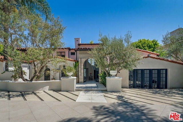 mediterranean / spanish-style home with french doors