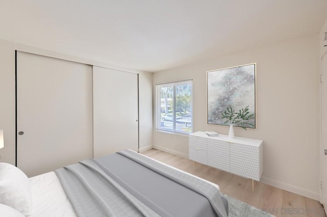 bedroom with light hardwood / wood-style flooring and a closet