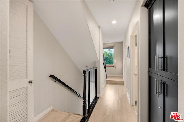 stairway featuring wood-type flooring