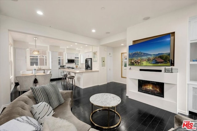 living room with dark hardwood / wood-style flooring