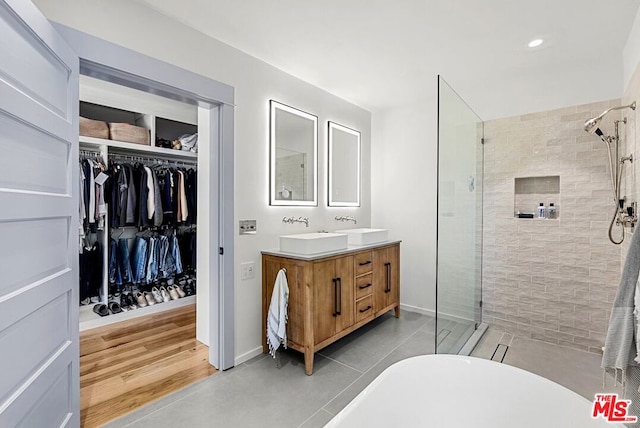 bathroom featuring vanity and shower with separate bathtub