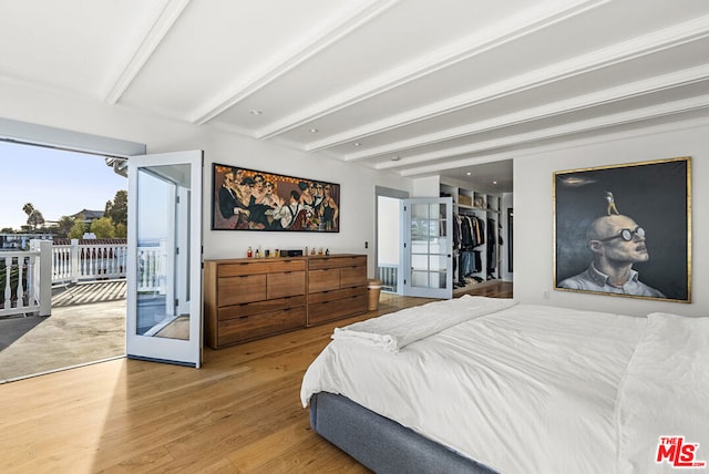 bedroom with access to outside, french doors, beamed ceiling, and hardwood / wood-style flooring