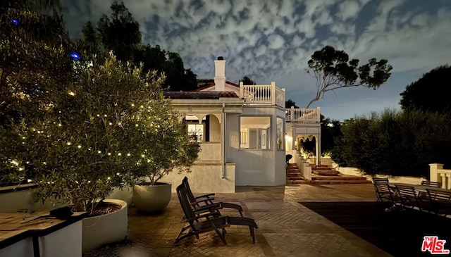 patio terrace at dusk with a balcony