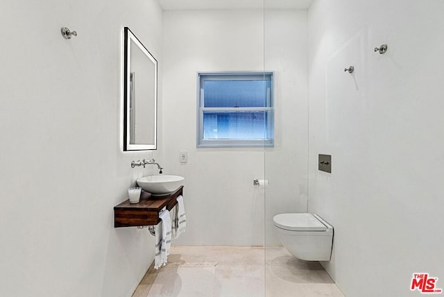 bathroom with tile patterned floors, toilet, and sink