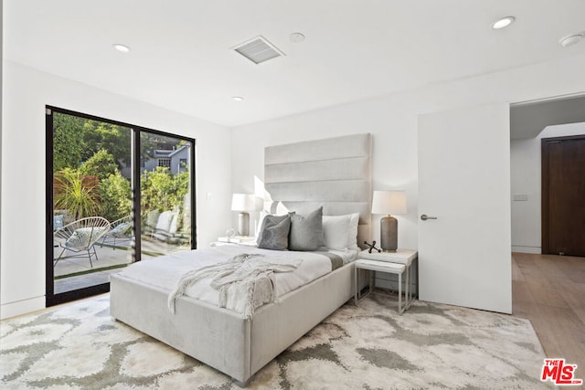 bedroom with access to outside and light hardwood / wood-style flooring