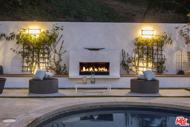 exterior space with a patio area and exterior fireplace