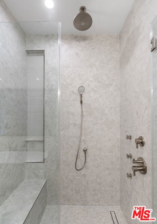 bathroom with a tile shower