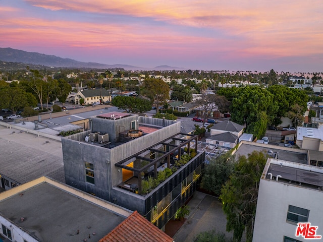 aerial view at dusk featuring a mountain view