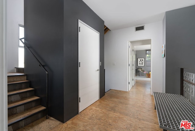 hallway with light hardwood / wood-style flooring