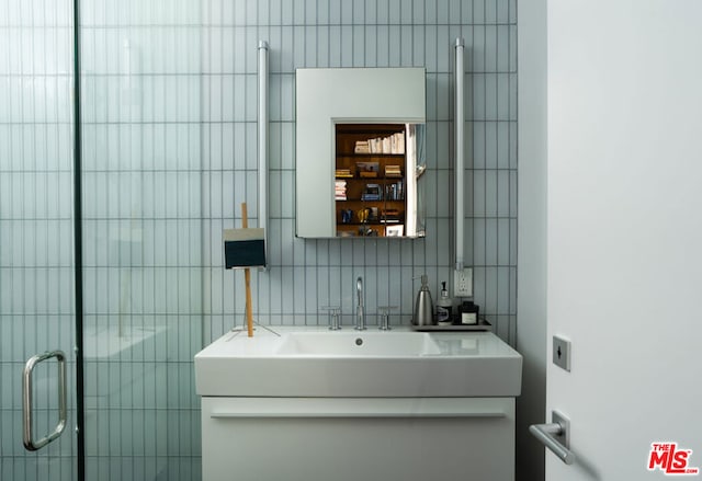 bathroom featuring vanity and a shower with shower door