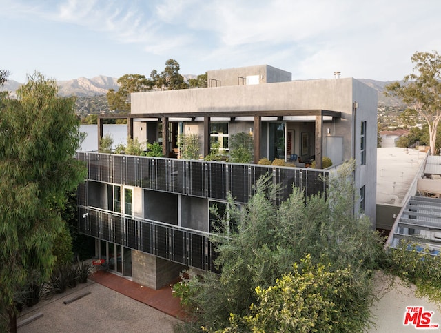 rear view of house with a mountain view