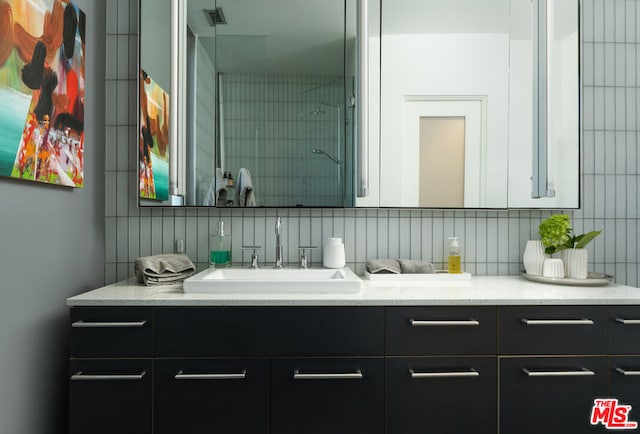 bathroom featuring decorative backsplash and vanity