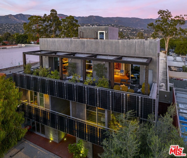 back house at dusk with a mountain view