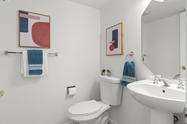 bathroom featuring toilet and sink