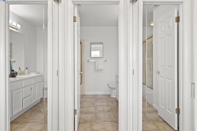 full bathroom with combined bath / shower with glass door, vanity, and toilet