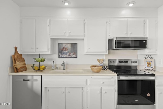 kitchen with white cabinets, stainless steel appliances, and sink