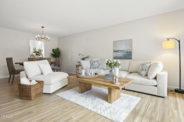 living room featuring a chandelier and light hardwood / wood-style floors