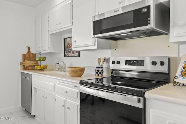 kitchen with stainless steel appliances, white cabinetry, and sink