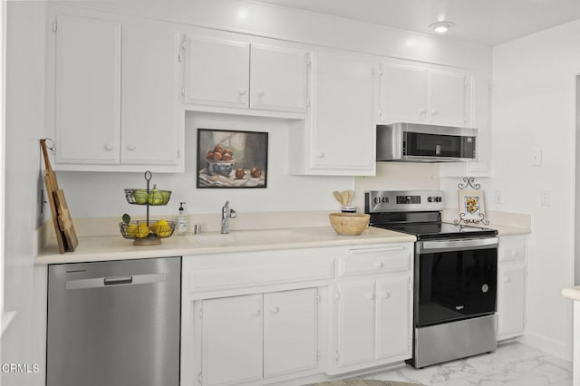 kitchen with white cabinets, stainless steel appliances, and sink