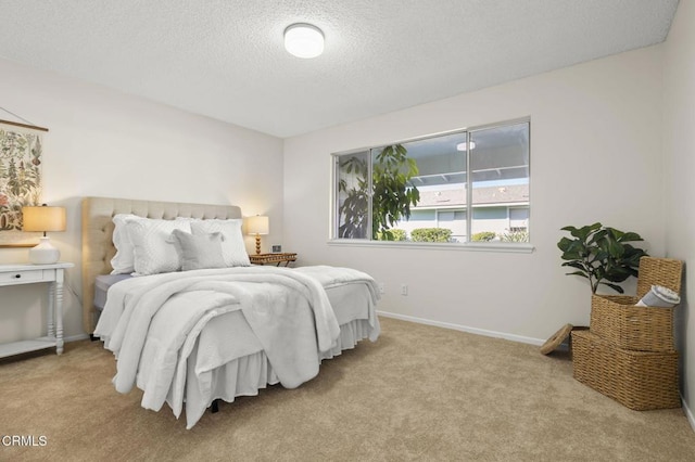 carpeted bedroom featuring a textured ceiling