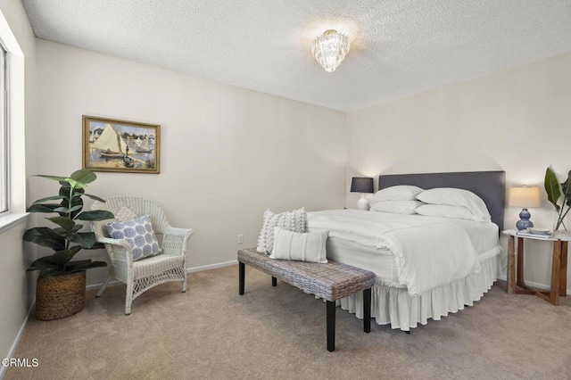 carpeted bedroom featuring a textured ceiling