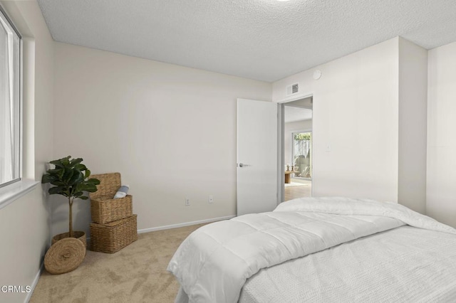 carpeted bedroom featuring a textured ceiling