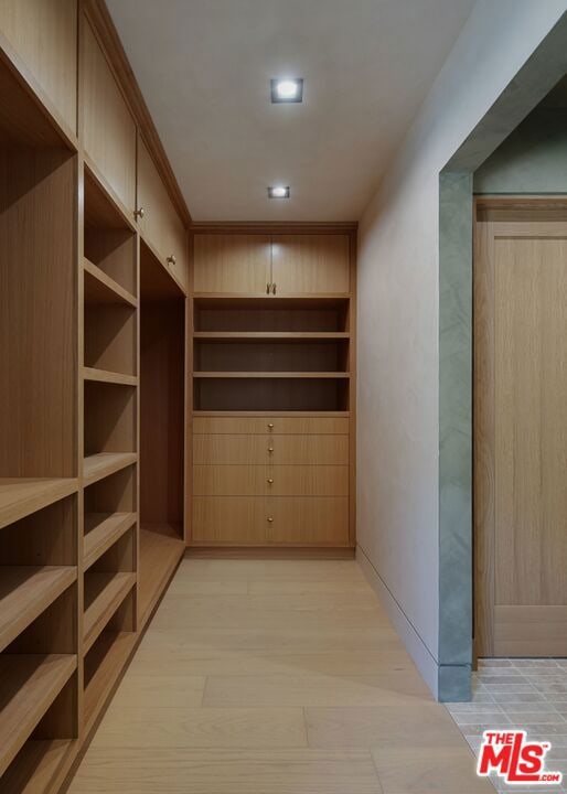 hallway with light hardwood / wood-style flooring