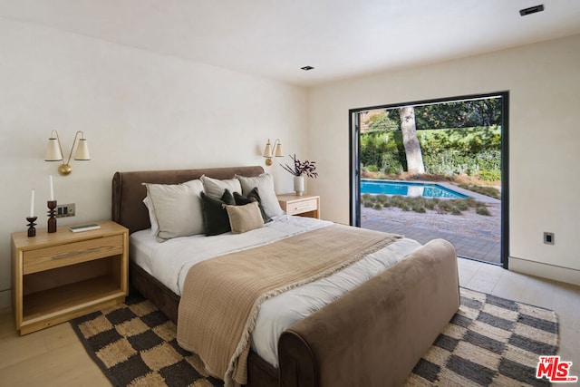 bedroom featuring access to outside and light hardwood / wood-style floors