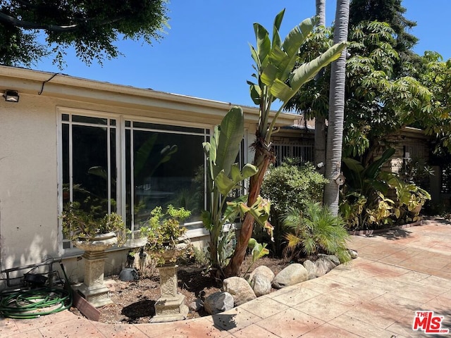 view of side of home with a patio