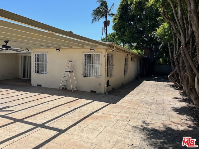 exterior space featuring a pergola and ceiling fan