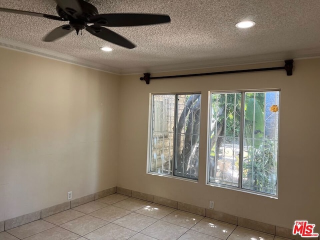 tiled spare room featuring ceiling fan and a textured ceiling