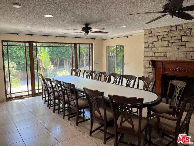 tiled dining area featuring ceiling fan and a textured ceiling