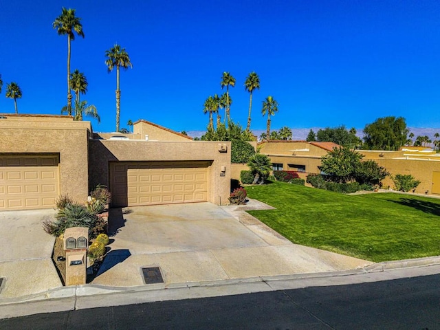 view of front of house with a garage and a front lawn