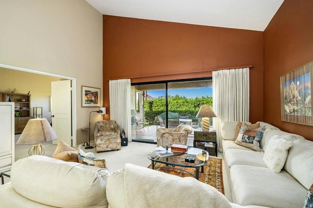 living room featuring carpet flooring and a high ceiling