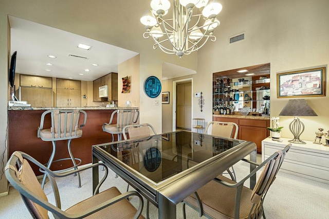 dining room featuring light carpet and an inviting chandelier