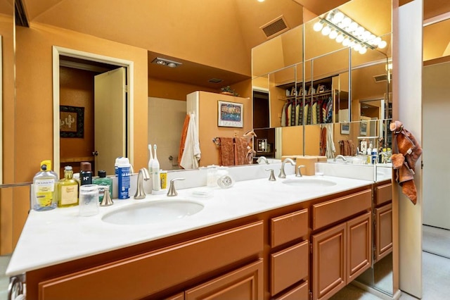 bathroom with vanity and vaulted ceiling