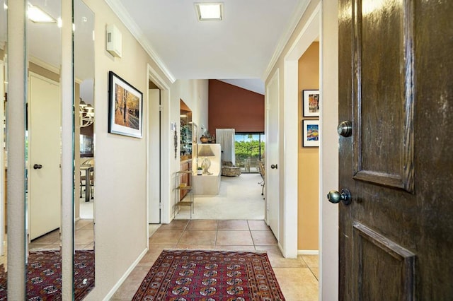 corridor featuring vaulted ceiling, crown molding, and light tile patterned flooring