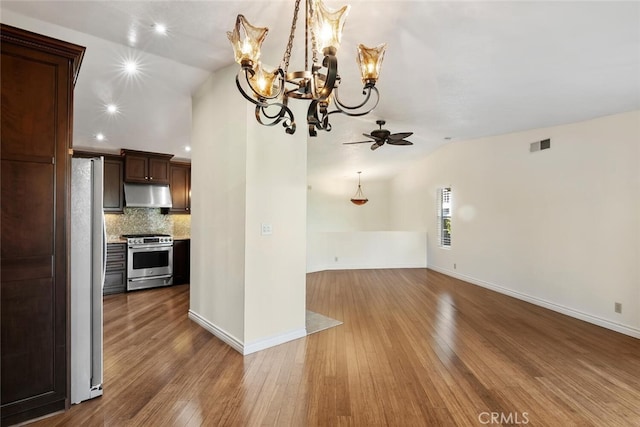 29121 Thousand Oaks Blvd Unit C, Agoura Hills, CA 91301 - kitchen featuring high end stainless steel range oven, under cabinet range hood, open floor plan, freestanding refrigerator, and lofted ceiling