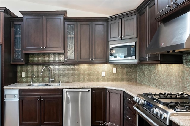 29121 Thousand Oaks Blvd Unit C, Agoura Hills, CA 91301 - kitchen with appliances with stainless steel finishes, range hood, a sink, dark brown cabinetry, and decorative backsplash