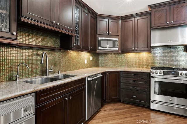 29121 Thousand Oaks Blvd Unit C, Agoura Hills, CA 91301 - kitchen with stainless steel appliances, a sink, light stone counters, and dark brown cabinetry
