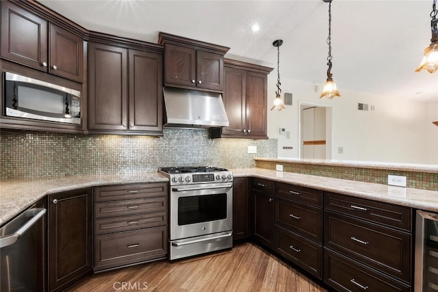 29121 Thousand Oaks Blvd Unit C, Agoura Hills, CA 91301 - kitchen with stainless steel appliances, under cabinet range hood, beverage cooler, dark brown cabinets, and recessed lighting