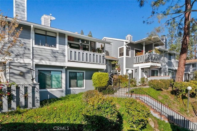 29121 Thousand Oaks Blvd Unit C, Agoura Hills, CA 91301 - back of property featuring a chimney and a balcony