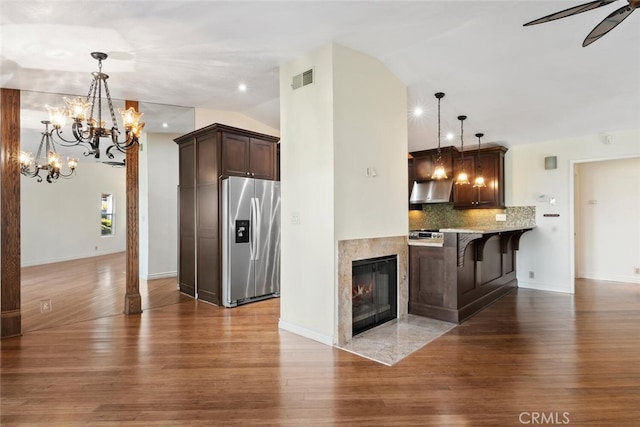 29121 Thousand Oaks Blvd Unit C, Agoura Hills, CA 91301 - kitchen with stainless steel refrigerator with ice dispenser, dark brown cabinetry, lofted ceiling, wood finished floors, and tasteful backsplash