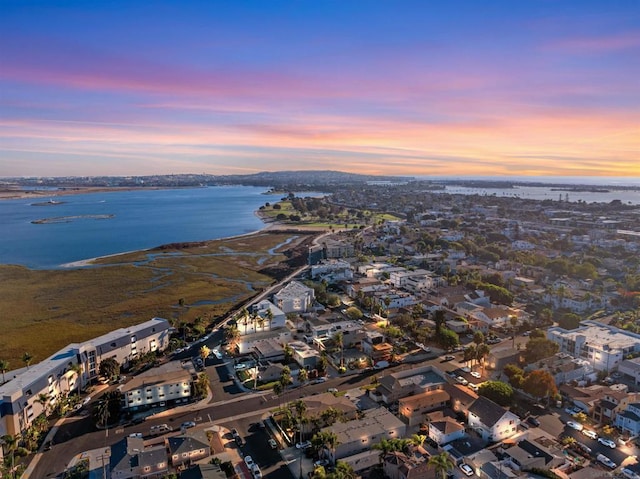 aerial view at dusk with a water view