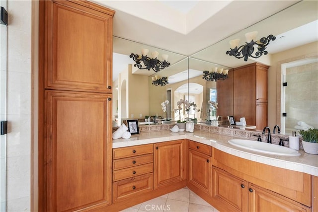 bathroom featuring tile patterned floors, vanity, and a shower with shower door