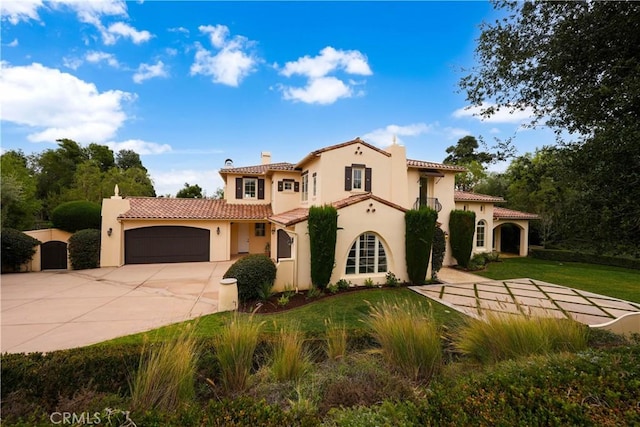 mediterranean / spanish home with a front lawn and a garage