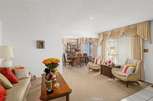 carpeted living room featuring a chandelier and a textured ceiling