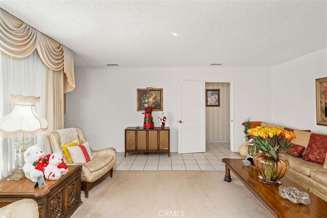 tiled living room featuring a textured ceiling